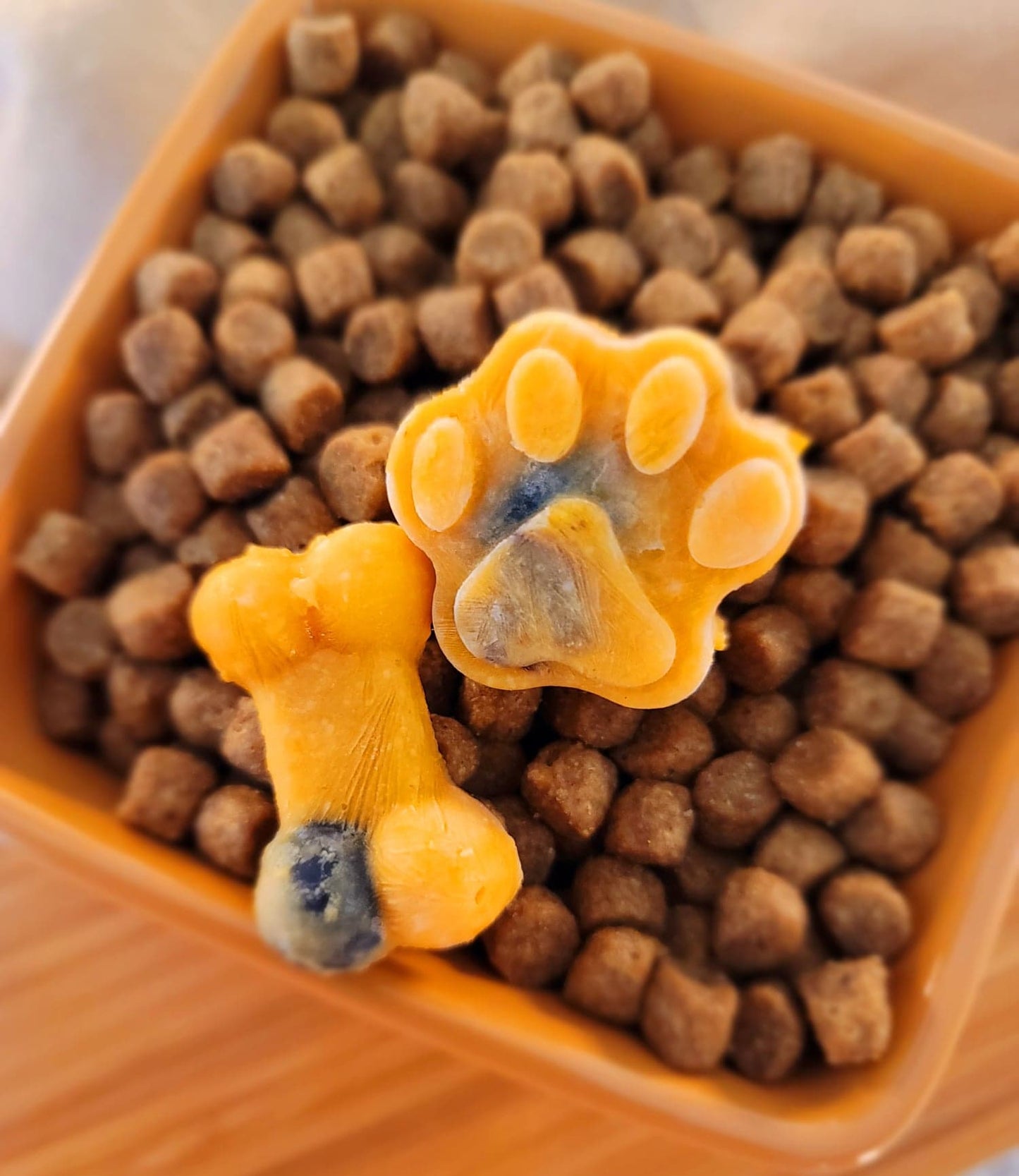 Example Paw & Bone shaped treats on top of dog food